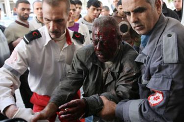 Palestinian paramedics help a wounded man walk into Gaza City's Al-Shifa hospital following Israeli artillery fire on the eastern sector near the border with Israel on January 22, 2011 in which one Palesitnian man was killed and two were wounded.
