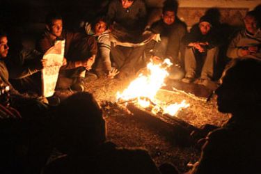 AFP / Egyptian demonstrators sit around a fire to keep warm in Tahrir Square, in central Cairo, on January 30, 2011, following a day when people gathered on the streets for a sixth day running calling for their President Hosni Mubarak to resign. AFP PHOTO/KHALED DESOUKIAFP PHOTO /