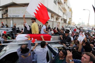 r_The body of a protester, who was killed by riot police, is taken for burial as his family members and supporters follow a march in Sitra, east of the Bahraini capital of Manama