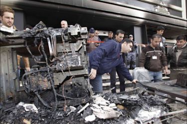 F_Employees look at the burnt equipment at the "Nalia" television station in Sulaimaniyah on February 20, 2011, after the station carrying live coverage of protests against the autonomous Kurdish region's
