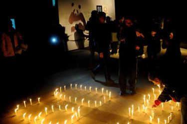 Sichuan, CHINA This photo taken on March 26, 2011, shows people lighting candles as they take part in the Earth Hour