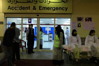 Doctors and nurses wait outside the Salmaniya Hospital for any injured people to be brought in from riots in Sitra, east of Manama, March 15, 2011. A local man was killed on Tuesday in clashes with police in the Shi'ite Muslim area of Sitra and several others were wounded, an opposition parliamentarian said, as unrest continued to wrack Bahrain.