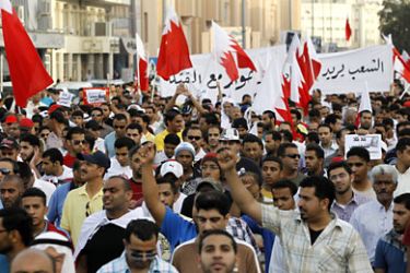 Anti-government protesters march and shout anti-government slogans in front of the Bahrain Immigration Directorate in Manama March 9, 2011. REUTERS