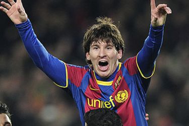 Barcelona's Argentinian forward Lionel Messi (up) is congratulated by his teamates during their Champions League round of 16, 2nd leg football match FC Barcelona vs Arsenal on March 8, 2011 at Camp