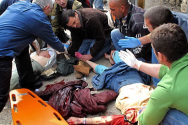 JERUSALEM, -, - : Israeli paramedics help wounded at the scene of a a massive explosion outside the Jerusalem's central bus station on March 23, 2011. AFP