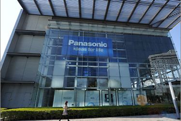 epa02706028 A Panasonic Corp. employee walks past the company's Tokyo headquarters in Tokyo, Japan, on 28 April 2011. Electronics manufacturer Panasonic Corp is to slash some 40,000 from its group workforce of around 380,000 in two years