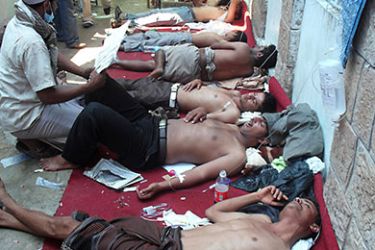 Yemeni demonstrators are given medical aid as they rest in a mosque following clashes with the police during a protest against the rule of President Ali Abdullah Saleh in Yemen's southwestern city of Taiz