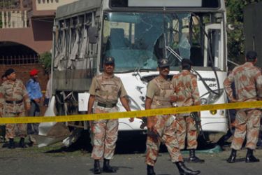 Paramilitary soldiers arrive at the scene after a bus carrying Pakistan Navy officials was hit by a bomb in Karachi April 26, 2011. Two bombs exploded near buses carrying navy officials in Pakistan's southern city of Karachi on Tuesday, killing one man and wounding over 30, officials said
