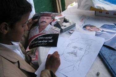 الطفل احمد عباس يرسم صورة فقيد الفرقة أولى مدرع الشرعبي (الجزيرة نت )