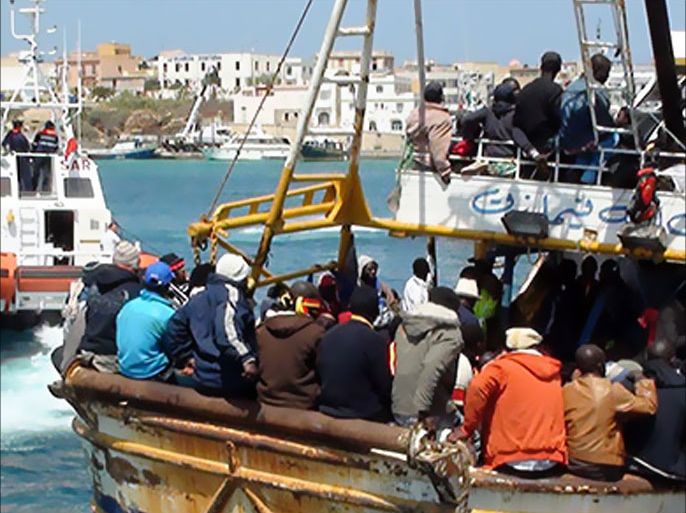 Refugees who flew Libya arrive on a boat on the Italian island of Lampedusa on April 19, 2011. 760 people were aboard a 20-meter boat arriving from Libya. AFP PHOTO