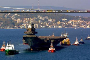 The Chinese aircraft carrier 'Varyag' passes Bosporus bridge in Istanbul, Turkey, Thursday, 01 November 2001. The congested Bosporous Strait was closed to shipping traffic Thursday to allow the aircraft carrier to be towed through, after a wait of several months, Anatolia news agency reported.
