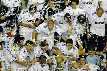 SPAIN : Real Madrid's players celebrate with the trophy after winning the Spanish Cup final match Real Madrid against Barcelona