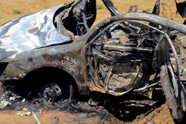 A picture taken on April 6, 2011 shows the debris of a burnt car that was targeted by an air strike by a plane which Sudanese officials said flew in from the Red Sea then headed back in the same direction, killing two people in the coastal city of Port Sudan.