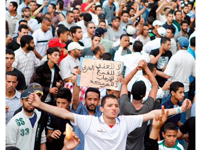 Protesters shout anti-government slogans during a pro-democracy demonstration organised by the "February 20 Movement", who are demanding political reforms, in Casablanca May 29, 2011. Police used truncheons to break up an anti-government protest in Morocco's commercial capital, Casablanca, on Sunday and dozens of people were injured, organisers said. The placard reads "No to violence, no to repression and no to terrorism". Picture taken on May 29, 2011.