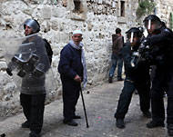 شرطة إسرائيليون يمرون بعجوز فلسطيني خلال المواجهات في القدس القديمة (الفرنسية)
