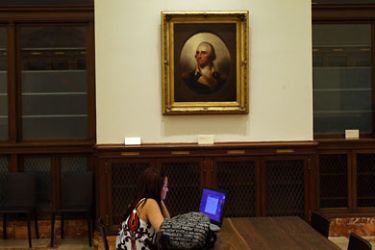 NEW YORK - JULY 20: Under a portrait of George Washington a woman works on her computer in a newly opened reading room at the New York Public Library specifically for online users on July 20, 2009 in New York