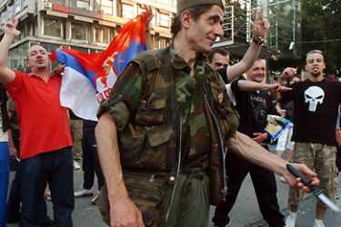A Serbian ultra nationalist among other supporters of Ratko Mladic shows a knife as they try to stage a protest in Belgrade on May 26, 2011. Serbia today announced the arrest of former Bosnian Serb military chief Ratko Mladic, ending a 16-year manhunt for the general accused of masterminding the Srebrenica massacre, Europe's worst since World War II. AFP PHOTO / STR