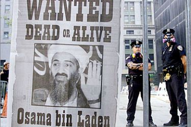REUTERS/ Police stand near a wanted poster of Saudi-born militant Osama bin Laden, printed by a New York newspaper, in New York in this September 18, 2001 file photograph. Al Qaeda leader Osama bin Laden was killed in a firefight with U.S. forces in Pakistan on May 1, 2011, ending a nearly 10-year worldwide hunt for the mastermind of the Sept. 11