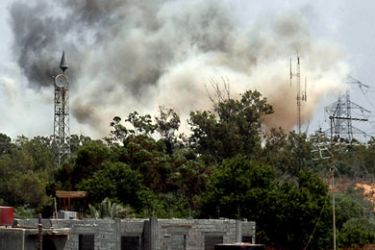 Smoke billows behind the trees following an air raid on the area of Tajura, 30 km east of Tripoli, as loud explosions rocked the Libyan capital on May 24, 2011 when NATO unleashed its heaviest blitz yet of the area in a bid to speed up the ouster of Libyan leader Moamer Kadhafi. AFP
