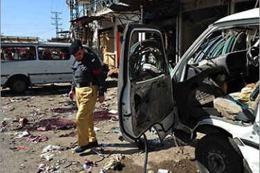 A Pakistani policeman examines the site of a suicide and bomb attack outside the main training center of Frontier Constabulary (FC) in Shabqadar town, about 30 kilometres (19 miles) north of Peshawar. Pakistan's