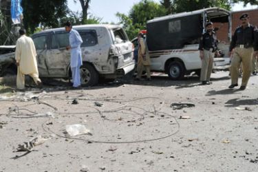 Pakistani police officials inspect the wreckage of a US consulate vehicle after a car bomb blast in Peshawar on May 20, 2011. A car bomb targeted US consulate vehicles in the north-western Pakistani city, killing one person and wounding 11 others in the first attack on Americans in Pakistan since Osama bin Laden was killed.