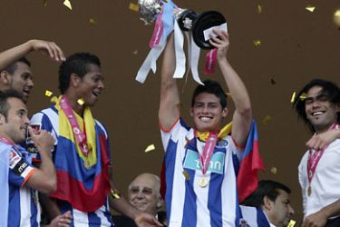 epa02746603 FC Porto's player James Rodriguez holds the trophy, after his team won the Portugal Cup