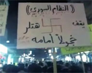 لافتة رفعها متظاهرون بسوريا تعبر عن نفسها  (الجزيرة)