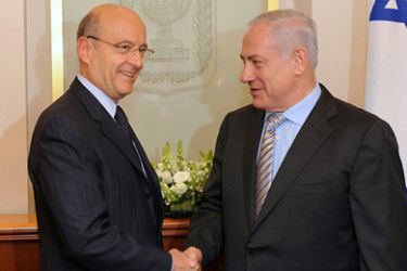 handout picture released by the Israeli Government Press Office on June 2, 2011, shows Israeli Prime Minister Benjamin Netanyahu (R) shaking hands with French Foreign Minister Alain Juppe, at the prime minister's office in Jerusalem. AFP PHOTO