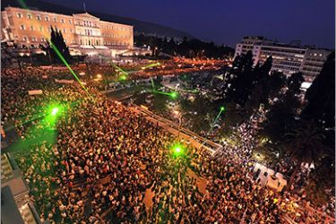 Tens of thousands of Greeks gather in front of the Greek Parliament for a peaceful demonstrations, in response to calls for protests across Europe, on June 5, 2011. Greeks took to the streets of Athens on the 12th consecutive day of protests against the government's draconian austerity measures. AFP PHOTO / LOUISA GOULIAMAKI