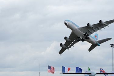 f_The Airbus A380 carrying the colours of Korean Air performs a flying display for visitors on June 20, 2011, after a demonstration version of the model clipped a structure by the taxiway on Sunday at the Paris International Air Show at Le Bourget airport near Paris.