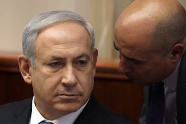 f_Israeli Prime Minister Benjamin Netanyahu listens to an adviser at the start of the weekly cabinet meeting at his Jerusalem office on June 26, 2011