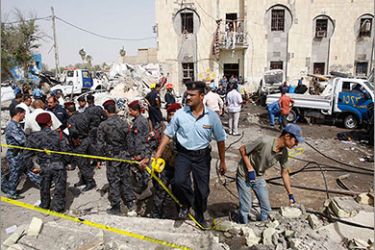 Security personnel inspect the site of a bomb attack in Basra, 550 km (342 miles) south of Baghdad, June 13, 2011. A suicide bomber blew up an explosives-filled vehicle at the entrance to a police unit in Iraq's southern oil port of Basra on Monday, killing five people and wounding 15, police and officials said. REUTERS
