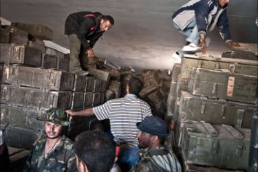 Libyan rebels seize a weapons depot, part of a network of bunkers belonging to Moamer Kadhafi's forces