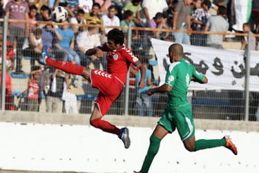 f_Two unidentified footballers from the national Palestinian (R) and Afghan teams battle for the ball during their World Cup 2014 qualifying match in the West Bank town of al-Ram on