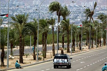A Jordanian security vehicle passes, 03 June 2003, on a boulevard leading from the Aqaba Airport to the waterfront palace of Jordan's King Abdullah who will host a Middle East summit tomorrow at his Aqaba palace. Two workers who were sweeping up dust on the road