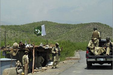Pakistani paramilitary forces ride a truck past a checkpoint in Manatu mountain at the central part of Kurram Agency, Pakistan's tribal belt bordering Afghanistan, during an operation against militants on July 10, 2011. The Pakistan Army said that it has taken over the control of the militants’ hideouts at Manatu mountain in central Kurram Agency while three dozen militants were also killed during the operation. AFP PHOTO/A. MAJEED