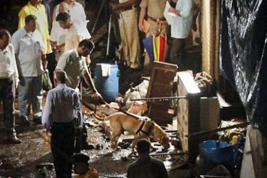 r_Police use a sniffer dog at the site of an explosion in the Zaveri Bazaar, south Mumbai July 13, 2011. Three bombs rocked crowded districts of Mumbai during rush hour on Wednesday, killing at least 20 people in the biggest militant attack on India's financial capital since 2008