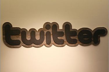 FILES) Twitter logo is displayed at the entrance of Twitter headquarters in San Francisco, California in this March 11, 2011 file photo. Twitter marked the fifth anniversary of its public launch on July 15, 2011