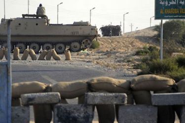 f_Egyptian security forces secure an area in Al-Kharuba village on the Sinai peninsula on August 19, 2011. An Egyptian security chief said a military operation in Sinai against militants uncovered a bomb-making factory and netted 20