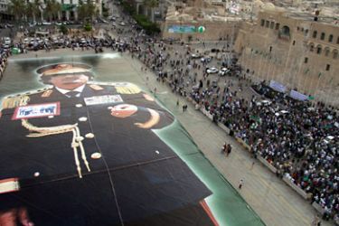 giant image of Libyan leader Muammar Gaddafi is unveiled at the Green Square in central Tripoli, Libya, 22 July