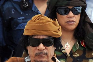epa02610435 (FILE) A file picture dated 29 August 2010 shows Libyan leader Muammar Gaddafi (front) followed by his female bodyguards on his arrival at Rome airport, Italy. Born in 1942 in Sirte, then Italian Libya, into a Bedouin family,