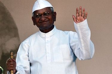 Anti-corruption activist Anna Hazare waves to supporters at the Ram Lila grounds on the 12th day of his hunger strike in New Delhi, on August 27, 2011. Indian hunger-striker Anna Hazare declared that the nation's people had won a great victory as he announced he would end his fast after wresting new concessions from lawmakers. Hazare, a 74-year-old social activist who said he was ready to die for his cause, had demanded that parliament agree to a tough new anti-graft law. AFP PHOTO/ MANAN VA