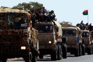 Anti-Gaddafi fighters prepare to fight Gaddafi loyalists at the outskirts of Herawa, 55 km east of Sirte, September 19, 2011.