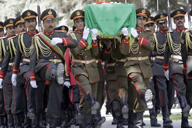 Afghan soldiers carry the coffin of slain Afghanistan High Peace Council and former president Burhanuddin Rabbani during his funeral at the Presidential Palace in Kabul on September 23, 2011. Afghan President Hamid Karzai vowed to continue efforts to broker a peace