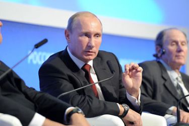 r_Russian Prime Minister Vladimir Putin (C) speaks during a plenary session of the third "Russia Calling!" investment forum organized by VTB Capital bank at Moscow World