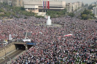 Tens of thousands of people rally in support of Syrian President Bashar al-Assad in Damascus on October 26, 2011, as an Arab delegation led by Qatar was headed for Syria for mediation between the Syrian government and its opponents.