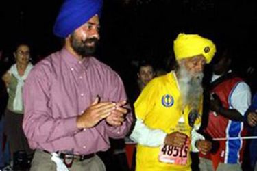 Fauja Singh (R), 92 of India, crosses the finish line after trying to break his own record for 90-and-over marathoners of 5 hours, 40 minutes, 44 seconds in the New York City Marathon Sunday 02 November 2003. Singh was running as a guest of a Sikh community in Queens, hoping to raise awareness of the faith. EPA/Hayden Roger CELESTIN