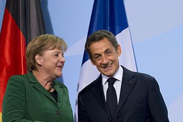 German Chancellor Angela Merkel and French President Nicolas Sarkozy shake handds after giving a statement on October 9, 2011 at the Chancellery in Berlin after a key summit on steps to combat debt turbulence in the Eurozone. The leaders of Europe's two biggest economies are expected in particular to try to hammer out details of a plan to recapitalise Europe's banks amid fears of a crippling credit crunch. AFP
