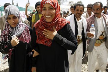 Yemeni winner of the Nobel Peace Prize Tawakul Karman (C) is congratulated by her supporters after winning the Nobel Prize, outside her tent in Tagheer Square in Sanaa October 7, 2011. Karman said on Friday the award was a victory for Yemen's democracy activists and they would not give up until they had won full rights in a "democratic, modern Yemen". REUTERS/Ahmed Jadallah (YEMEN - Tags: POLITICS SOCIETY PROFILE)