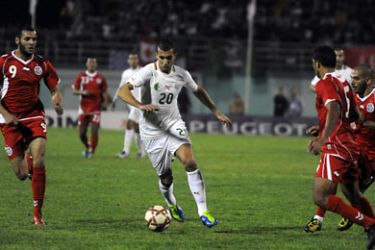 ف- Algeria's Tadjar Saad tunisie (2-L) vies for the ball with Tunisia's Chekami Yacine (L) during their